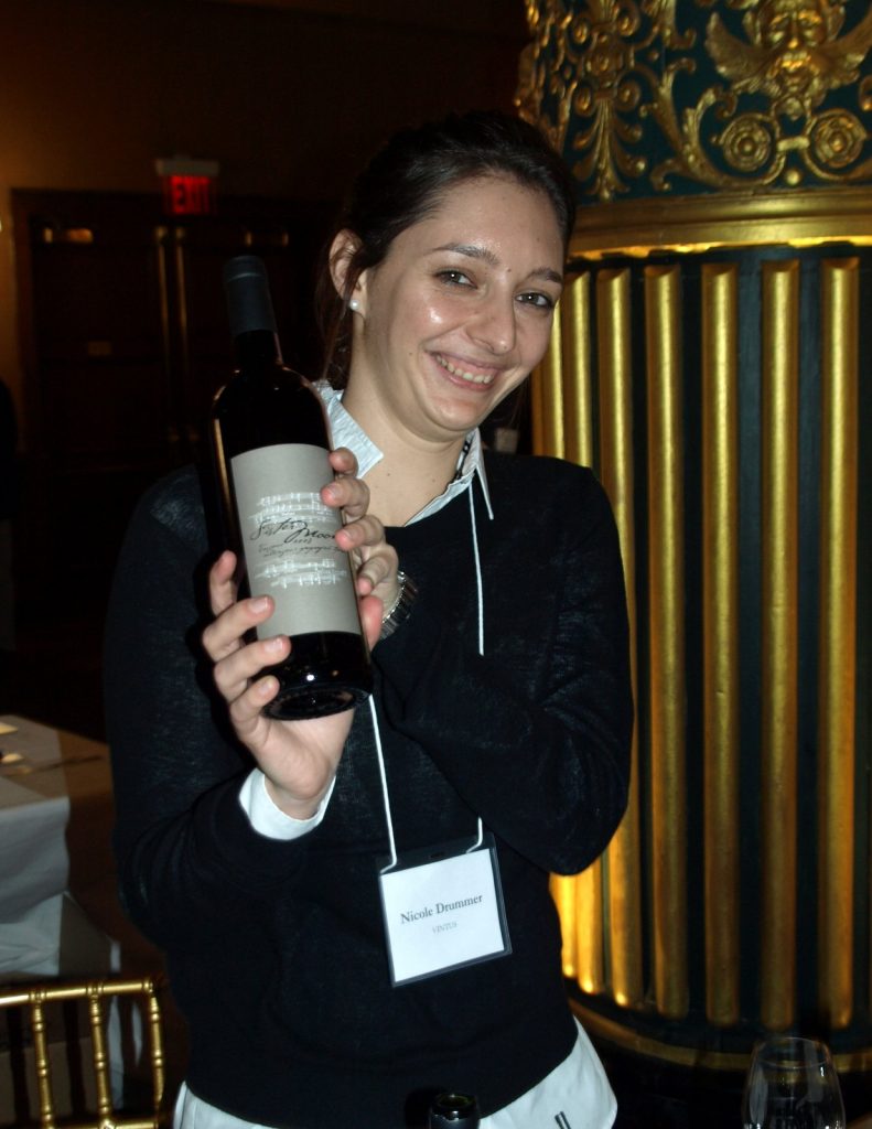 An image of Nicole from Il Paligio with a bottle of Sister Moon.